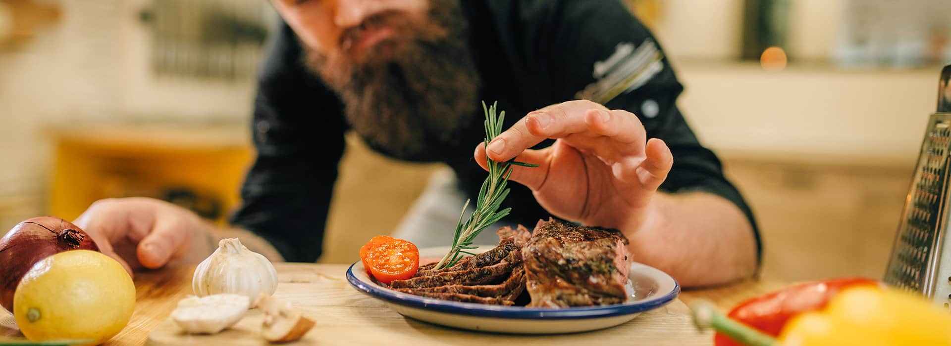 Image of a chef decorating the plate.