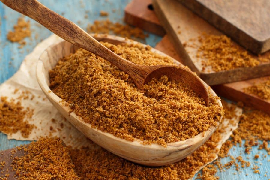 brown sugar in a wooden bowl with a wooden spoon