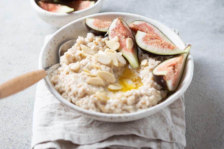 oatmeal porridge with toppings placed in a white bowl