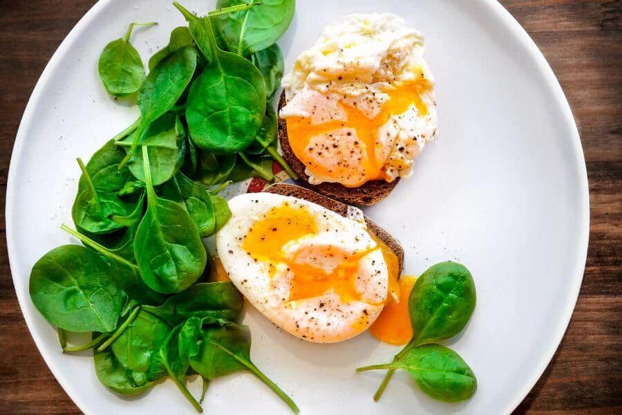 poached eggs on a bread with spinach